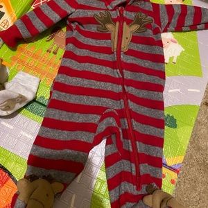 Three newborn size footy pjs by the brand Carter’s
